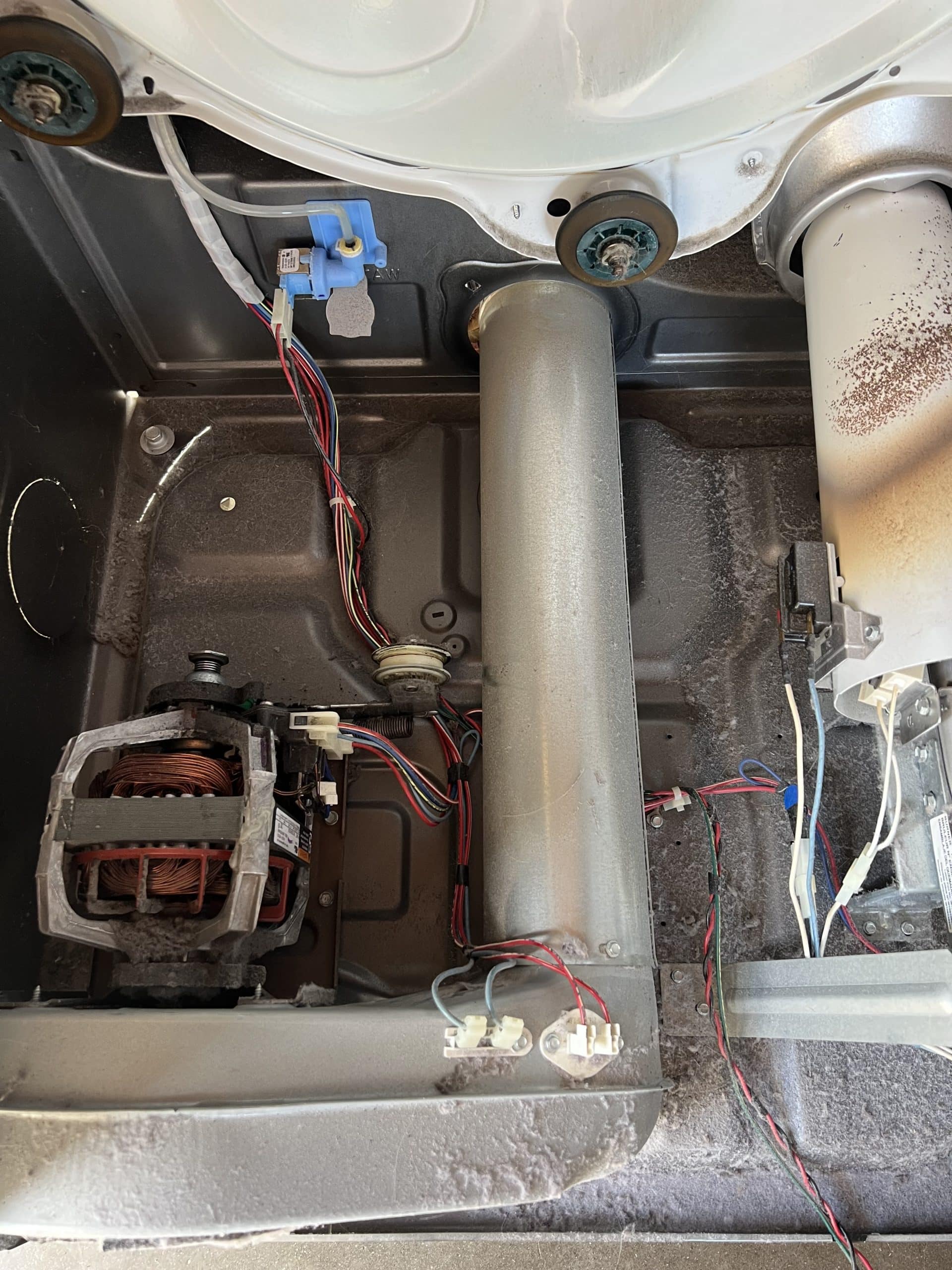 Dryer interior with heavy lint and dust before cleaning
