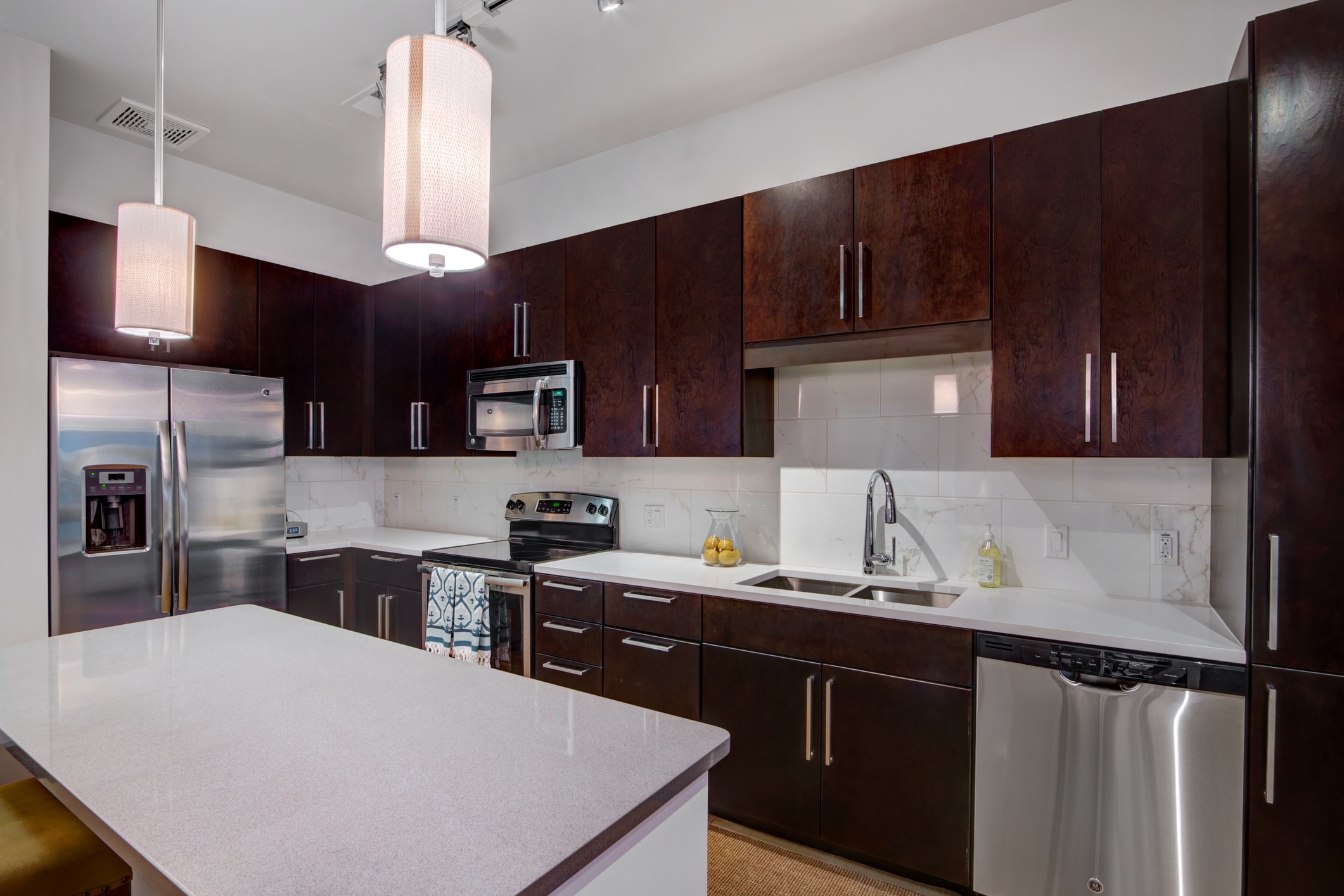 Modern kitchen with dark wood cabinets and stainless appliances