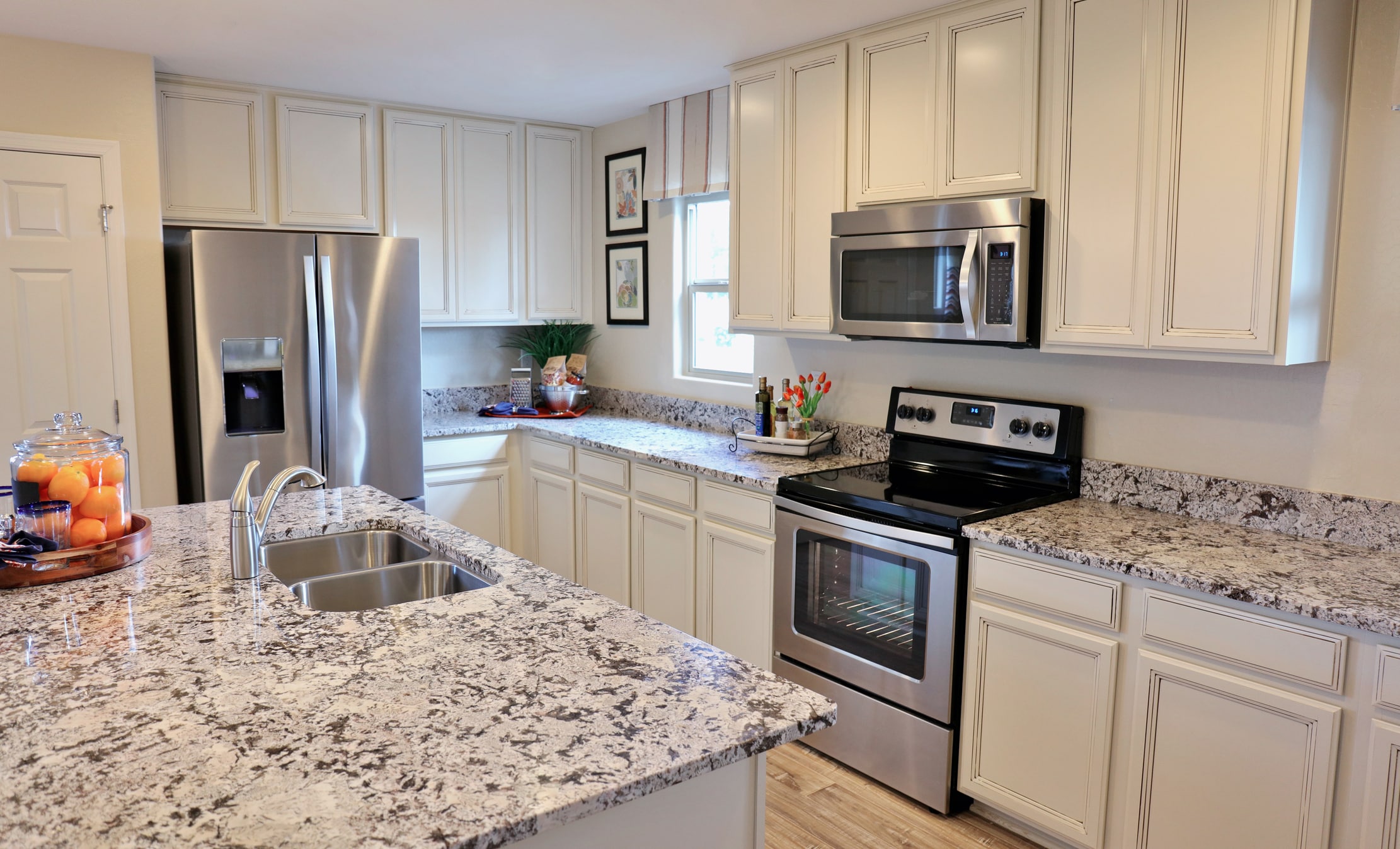 Modern kitchen with granite countertops and stainless appliances.