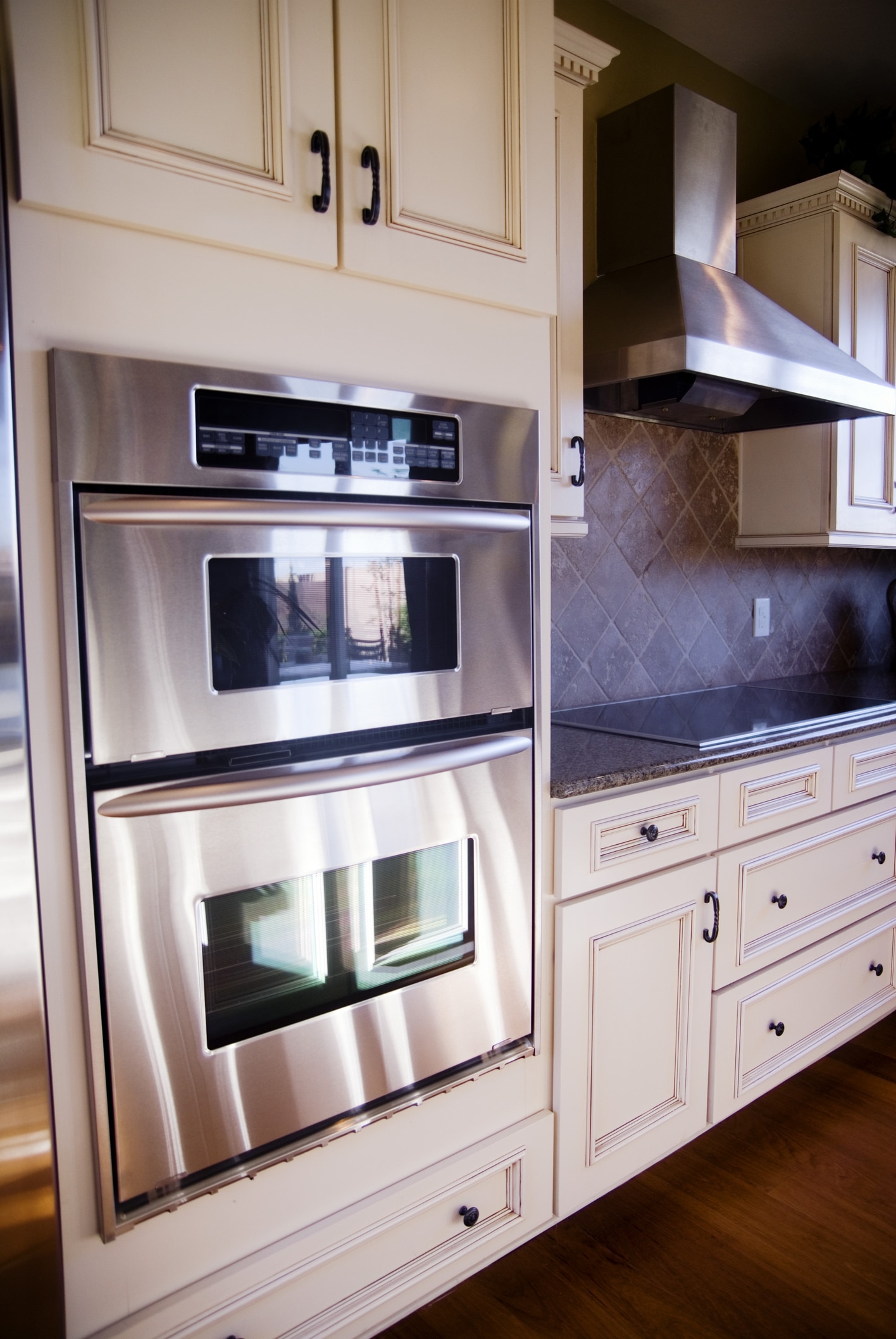 dreamstime_m_6275261 Appliance technician performing stove repair in Thousand Oaks kitchen with professional tools