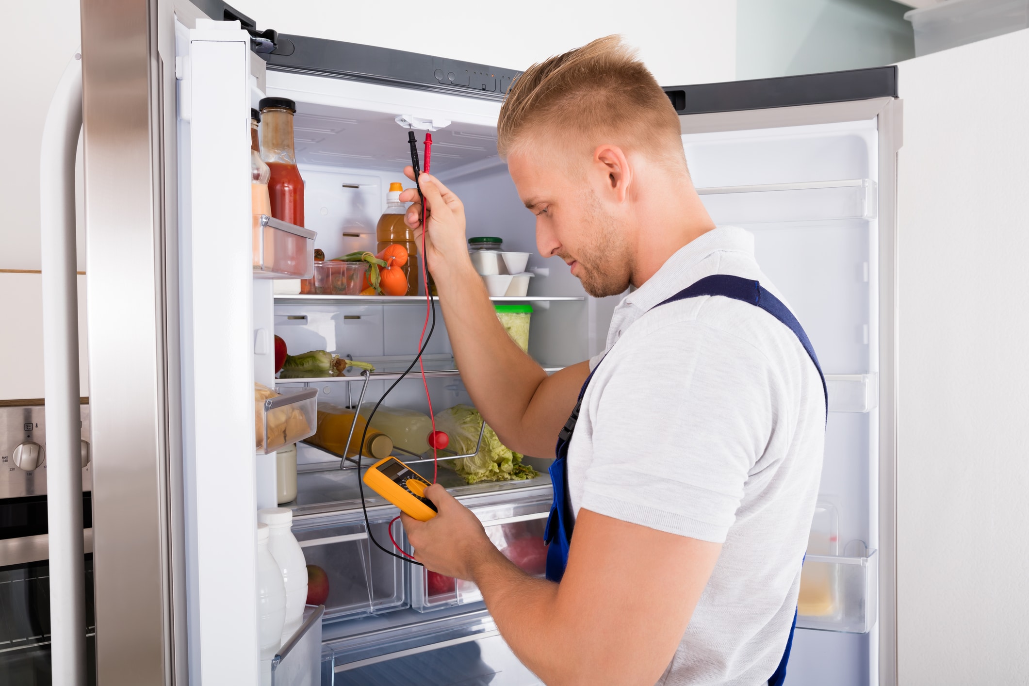 dreamstime_m_88091647 Calabasas refrigerator repair technician fixing kitchen fridge
